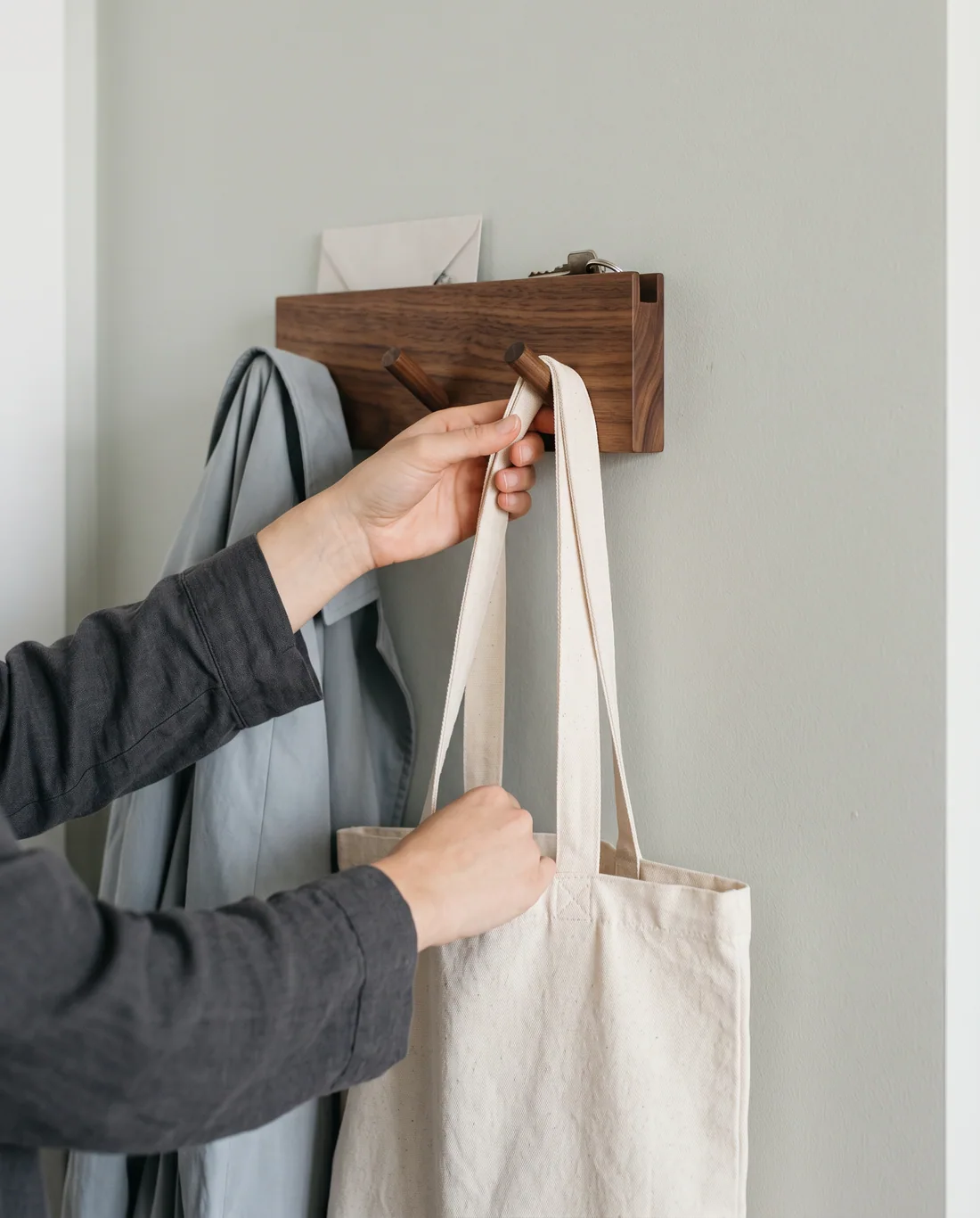 Illustrative close-up of a bag being placed on a wall hook
