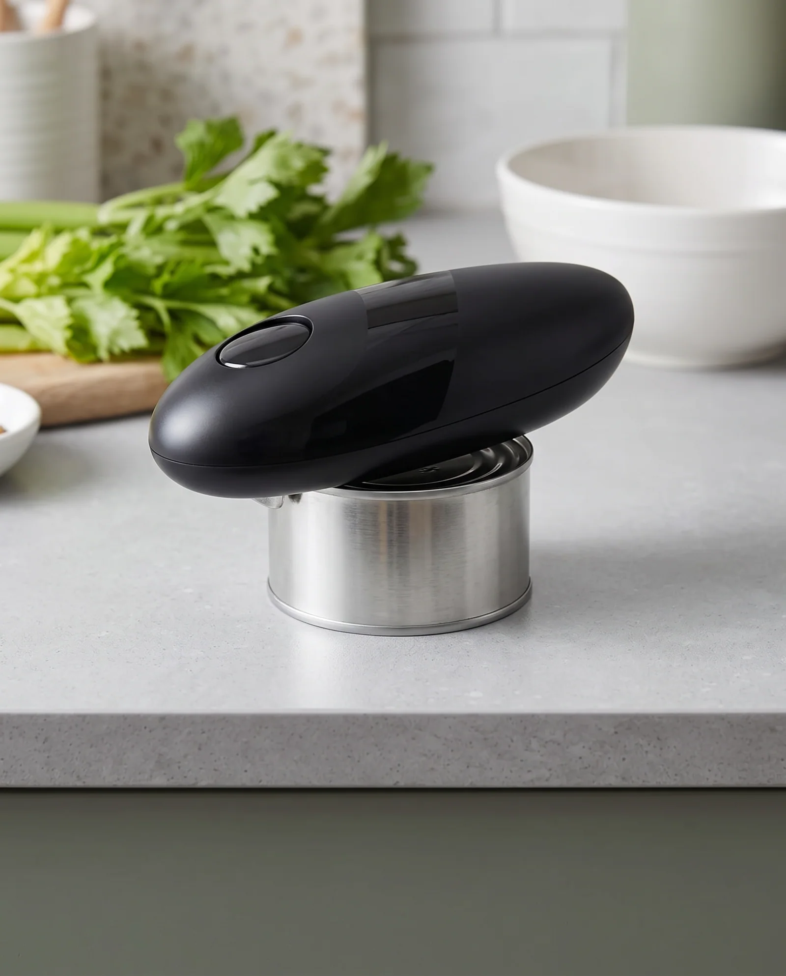 Illustrative close-up of a can opener on a clear kitchen counter