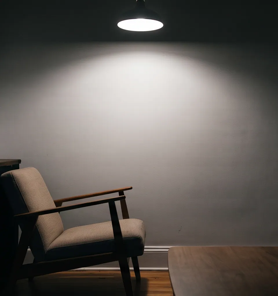Reading chair left in shadow by fixed ceiling lighting