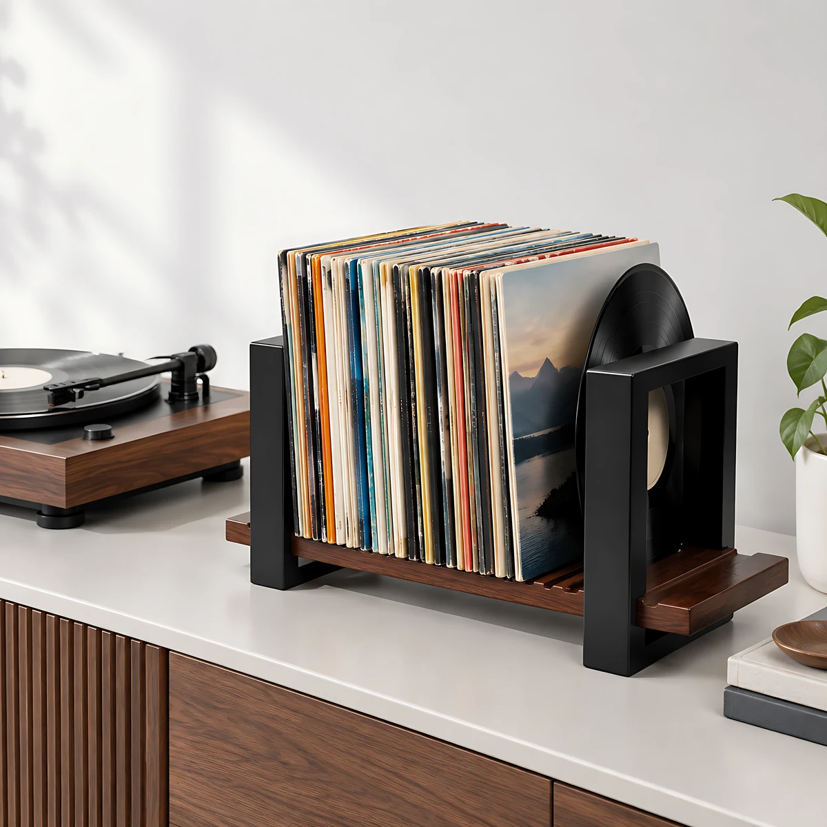Adjustable open vinyl record holder displaying albums beside a turntable