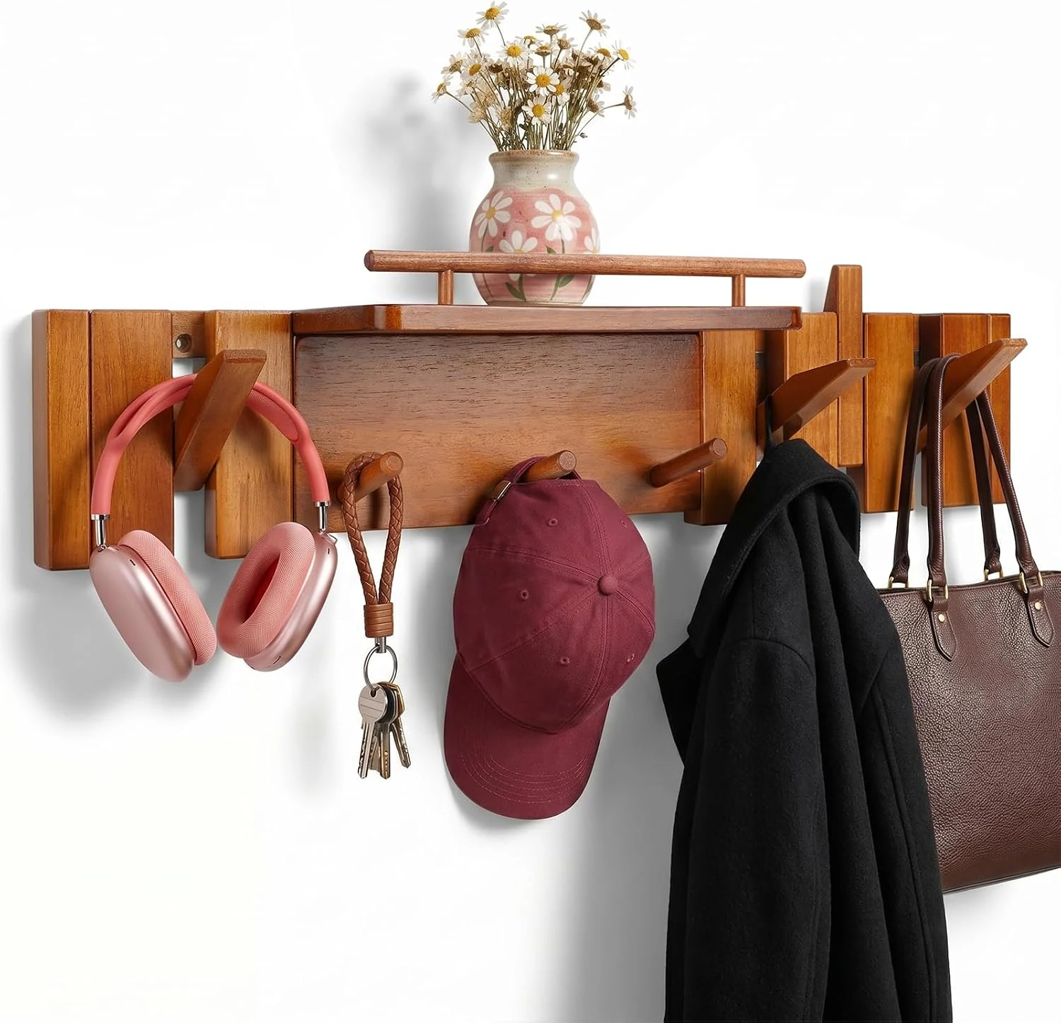Wall-mounted hanger holding daily accessories beneath a display shelf
