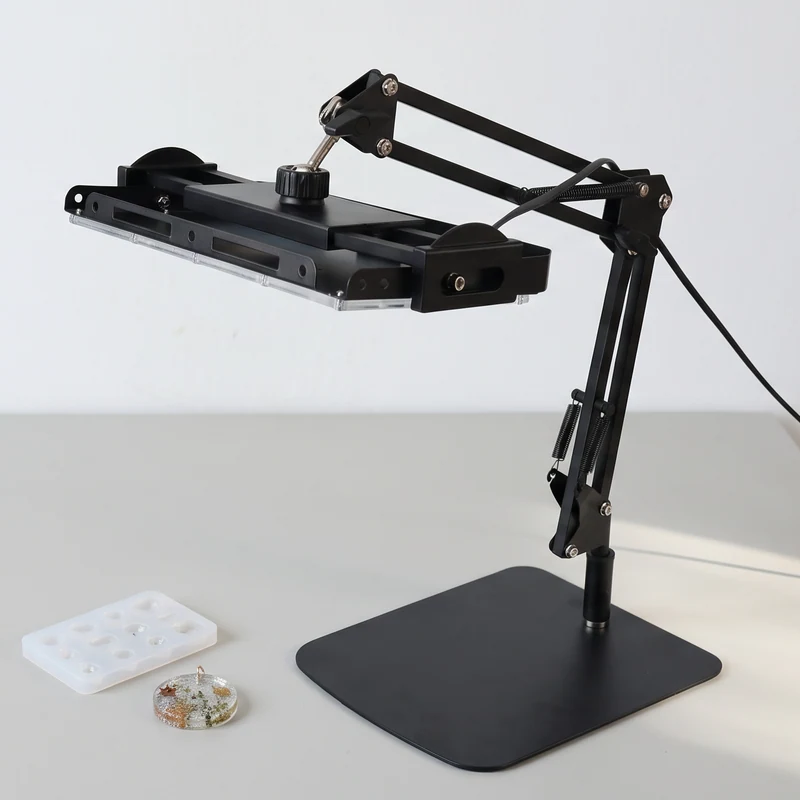 GISTAR articulated UV worklight with its square base resting on a craft workbench